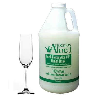A bottle of stockton brand aloe Vera with a champagne glass