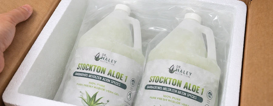 frozen bottles of aloe vera getting packed for shipping